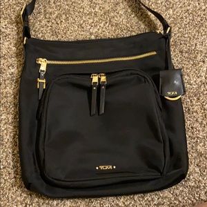 Tumi Voyageur Cross body bag with Gold hardware.